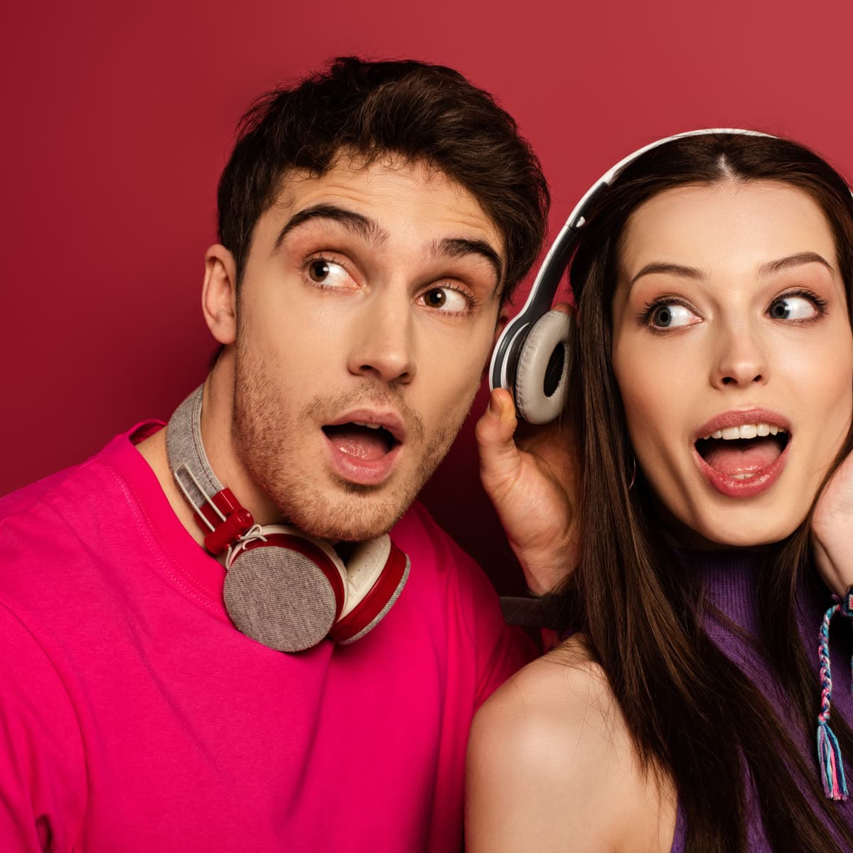 Young adults reacting to music while wearing headphones
