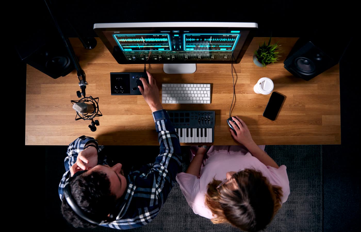Production team reviewing a track on a mixing desk